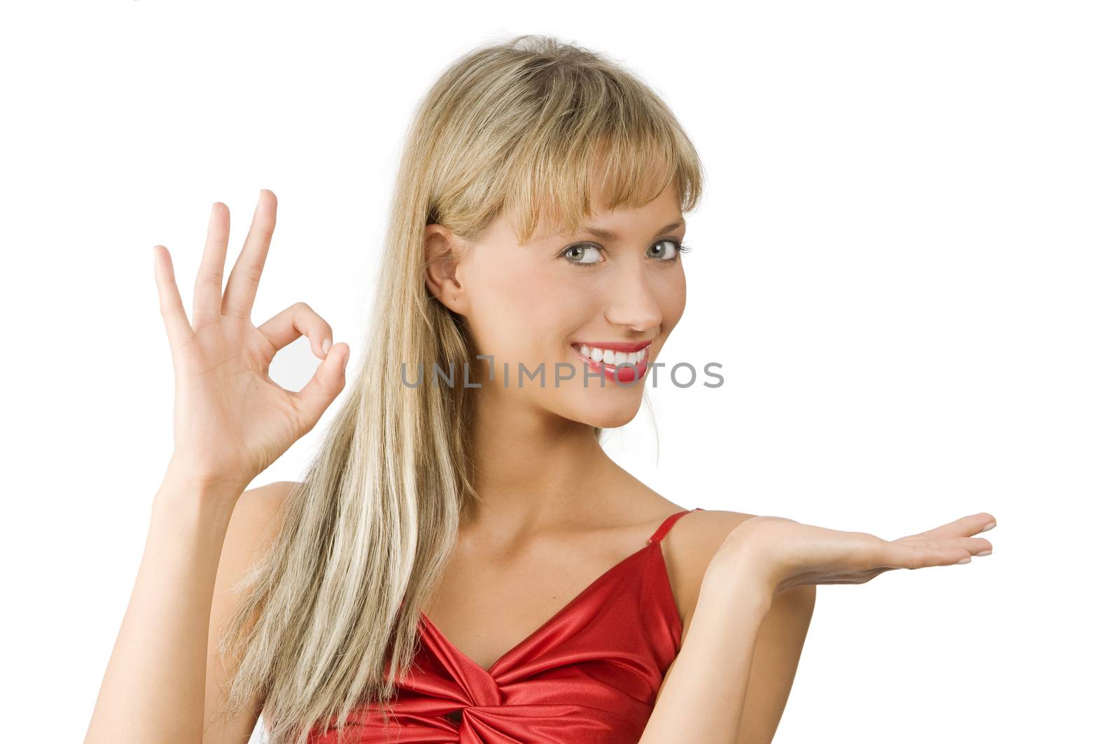 attractive and smiling woman in red dress presenting a product and doing OK with hand