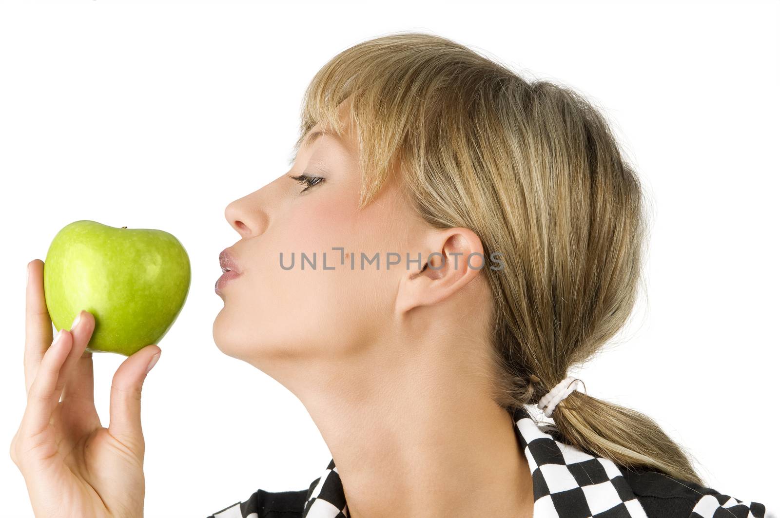 pretty blond girl kissing the green apple in her hand