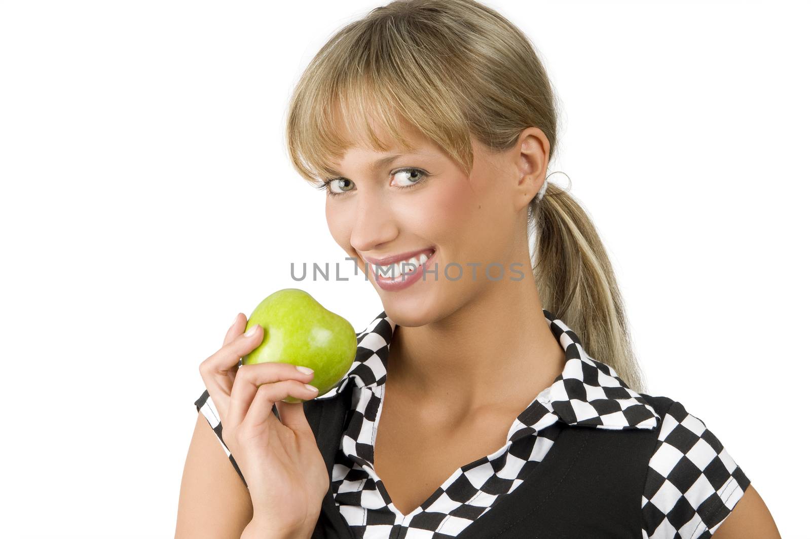pretty young woman with a green apple on one hand looking in camera and smiling