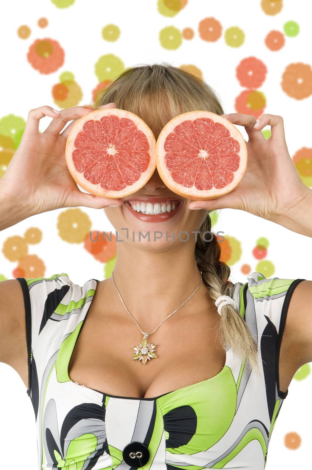 nice blond girl with green dress using grapefruit as glasses