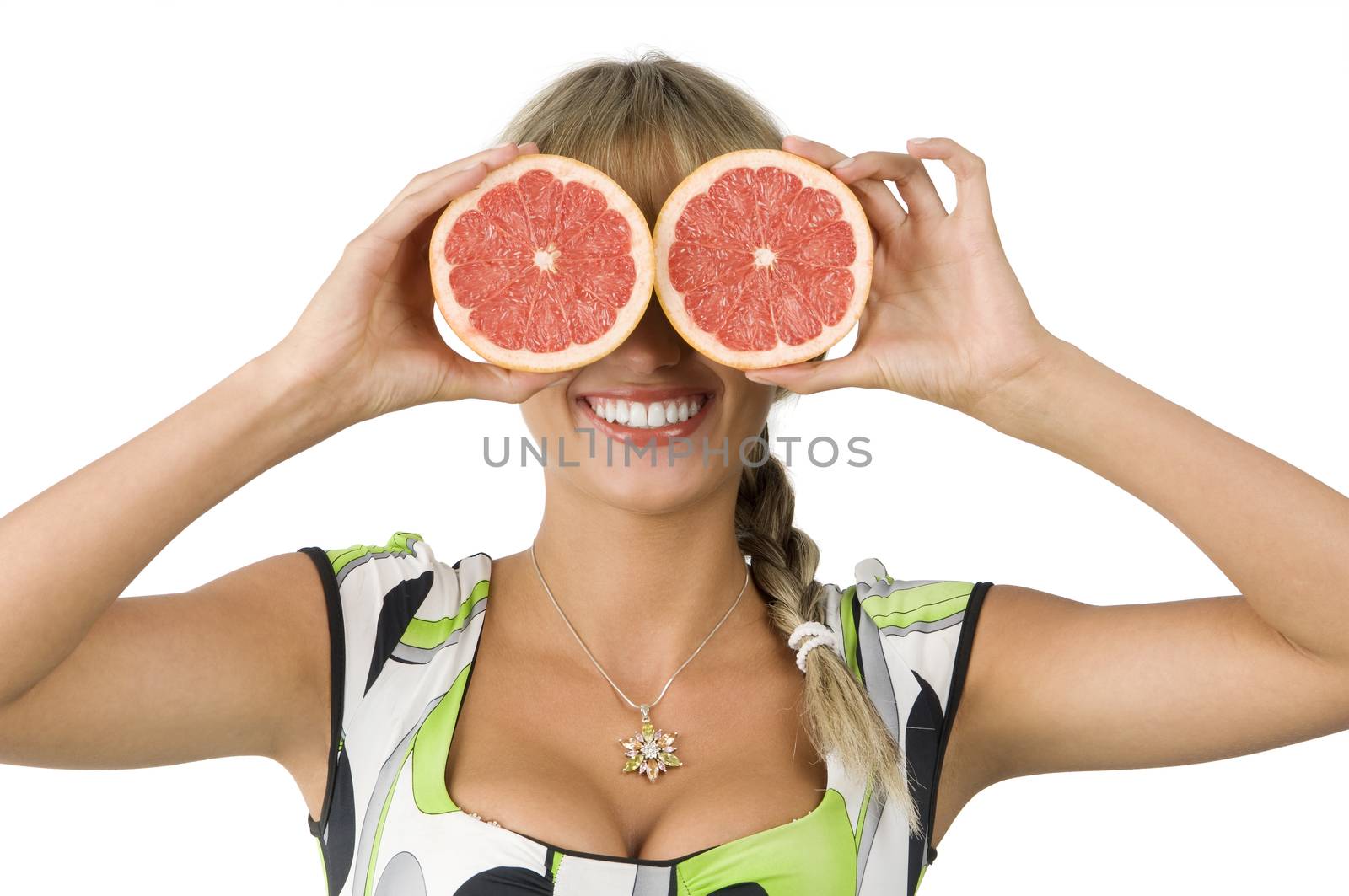 beautiful blond girl with green dress using grapefruit as glasses