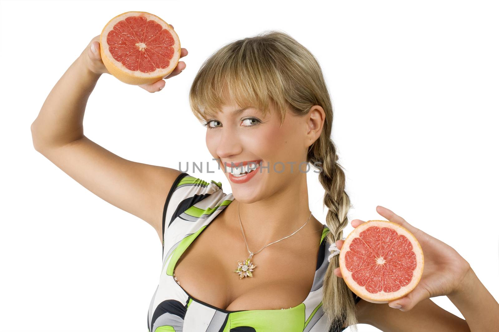happy and smiling blon girl with green dress and two half grapefruit in hands