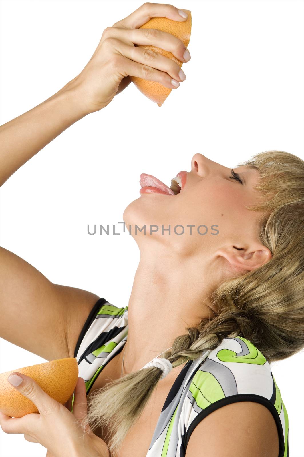 pretty girl with tongue out squeeze and drink juice from a grapefruit