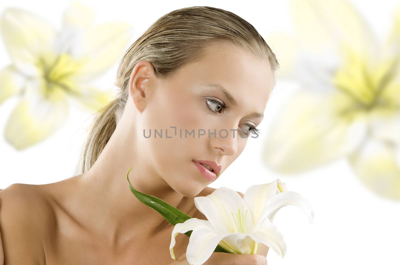 fresh young and beautiful woman with wet hair and a white lily