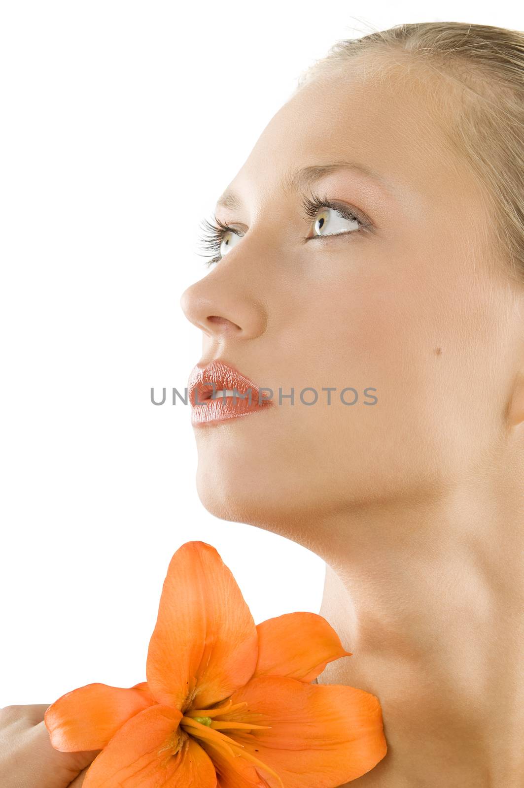 nice portrait of a blond girl with an orange lily and looking up