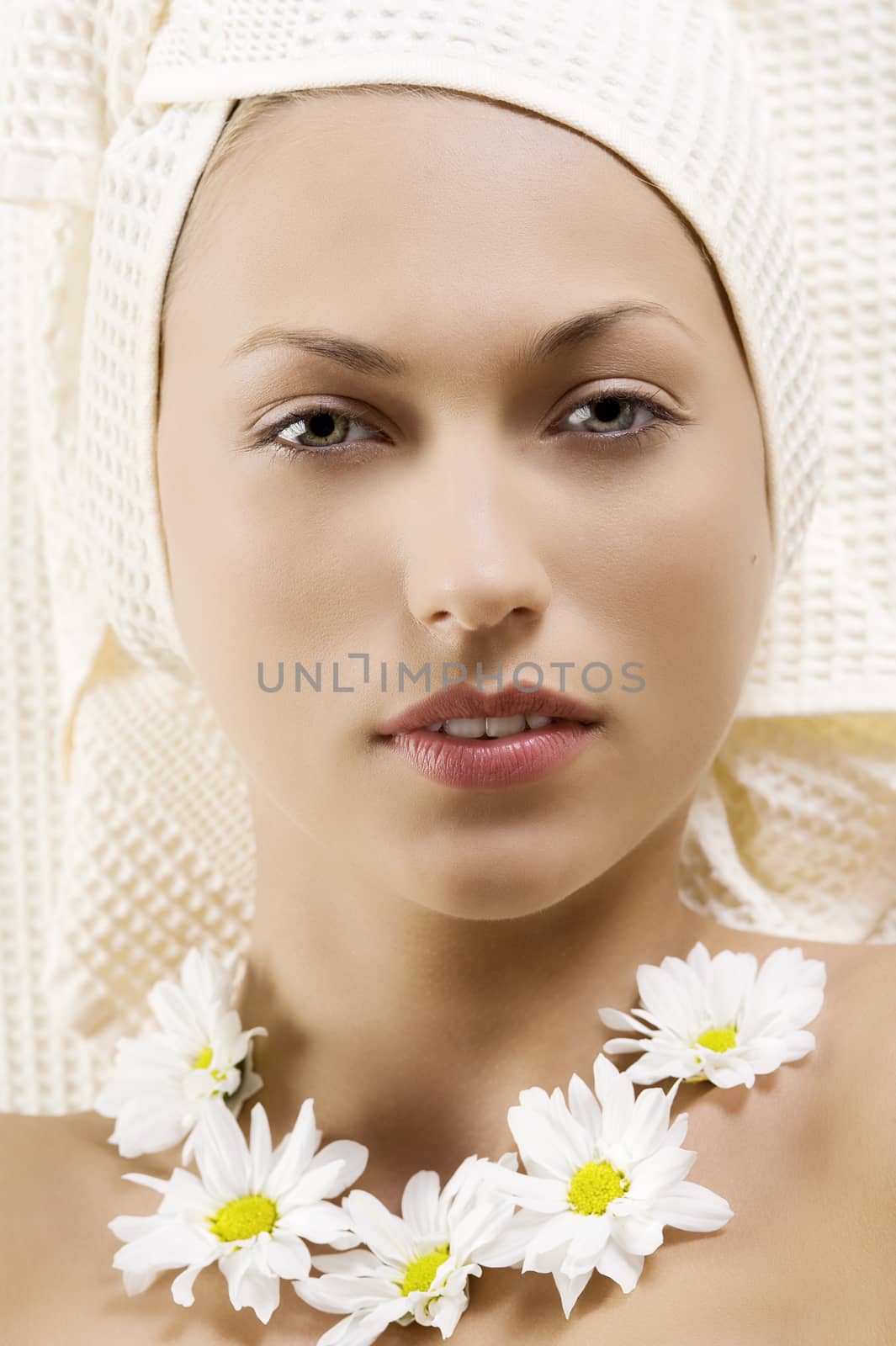 nice portrait of a young woman with bath towel and flowers on neck