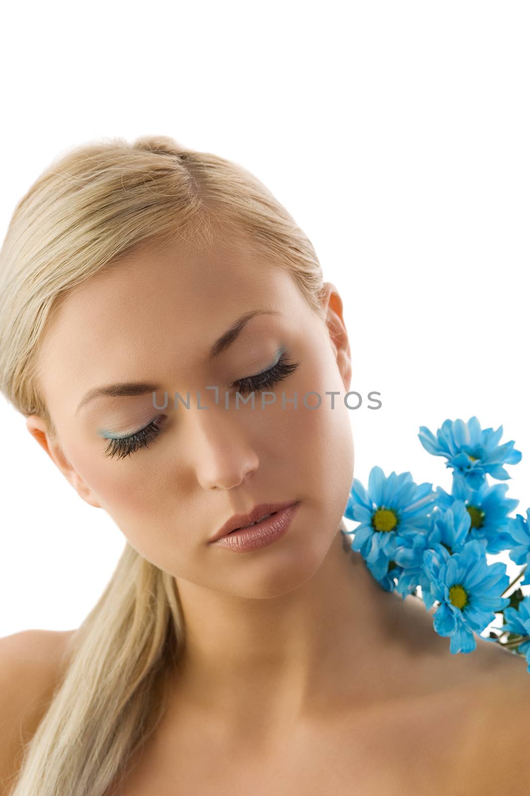 pretty blond girl in a beauty portrait with blue daisy on her shoulder