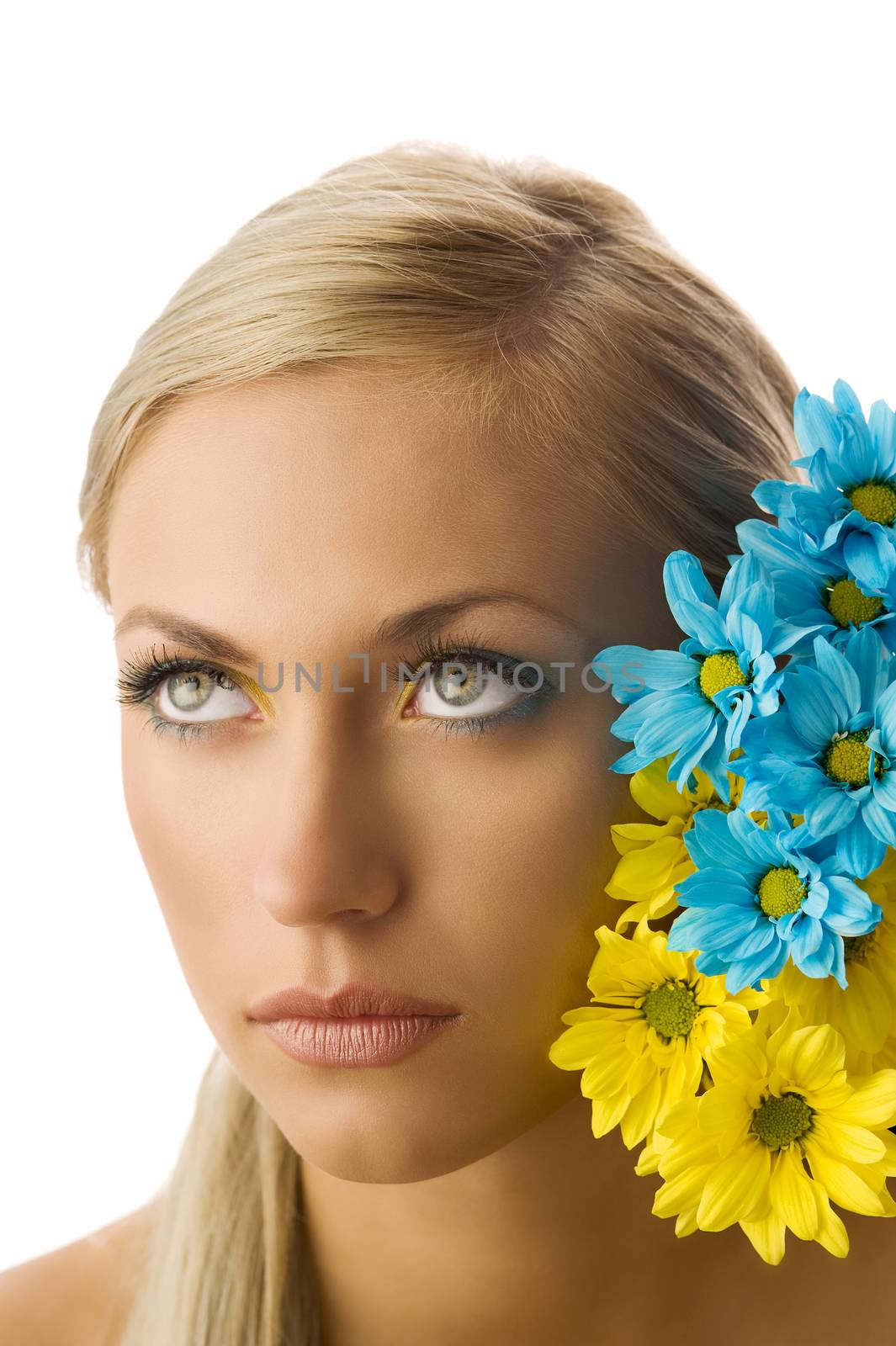 beauty portrait of pretty young blond girl with blue and yellow daisy and colored makeup