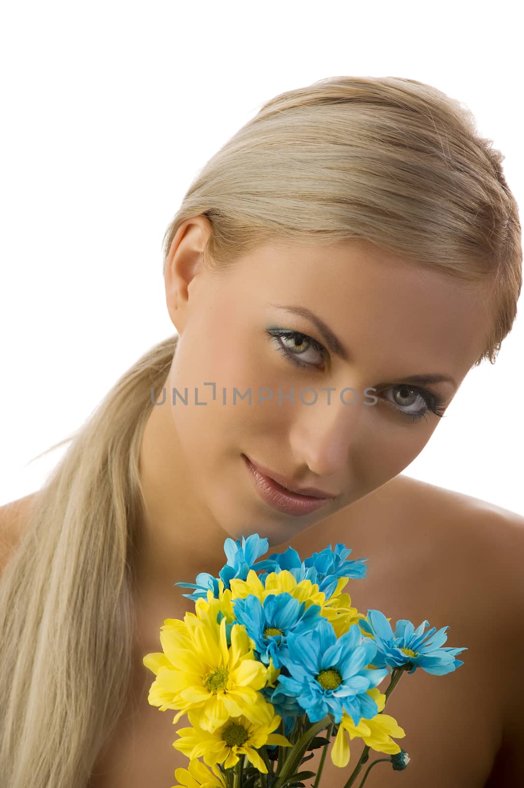 graceful model with colored make up and some flowers near face