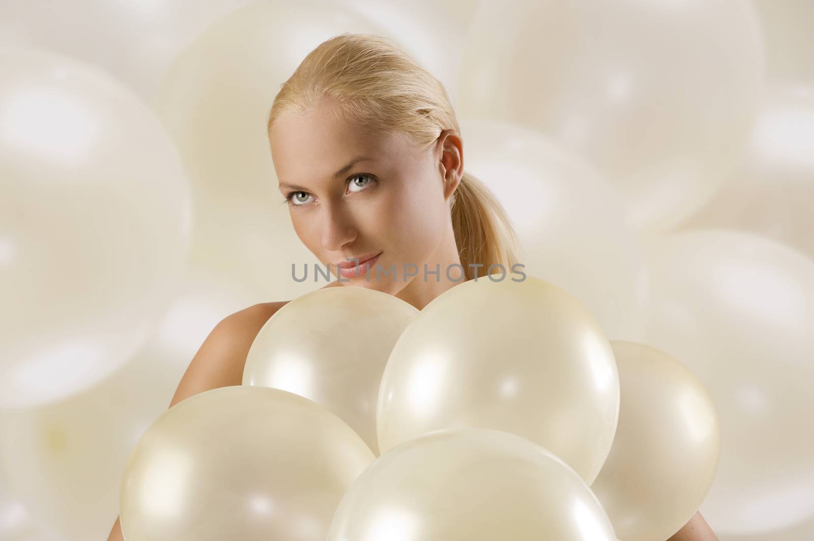 beautiful blond woman between white air balloons looking up