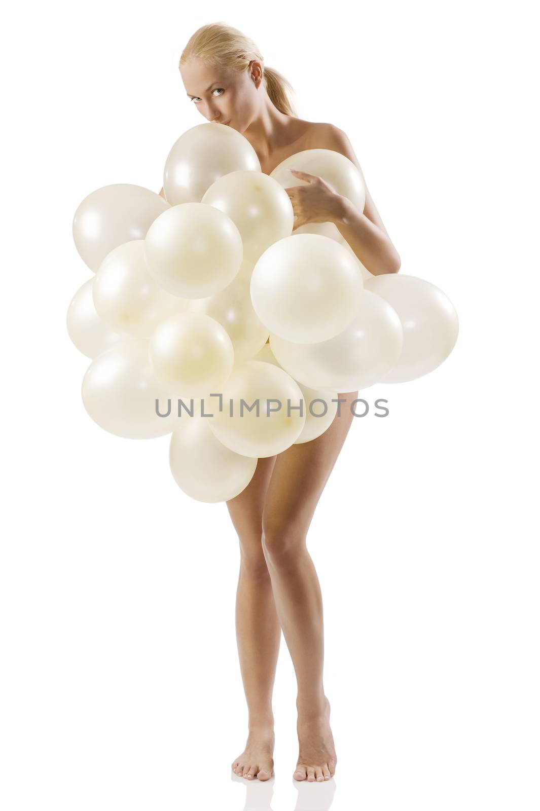 beautiful blond woman covering her naked body with white air balloons and kissing them