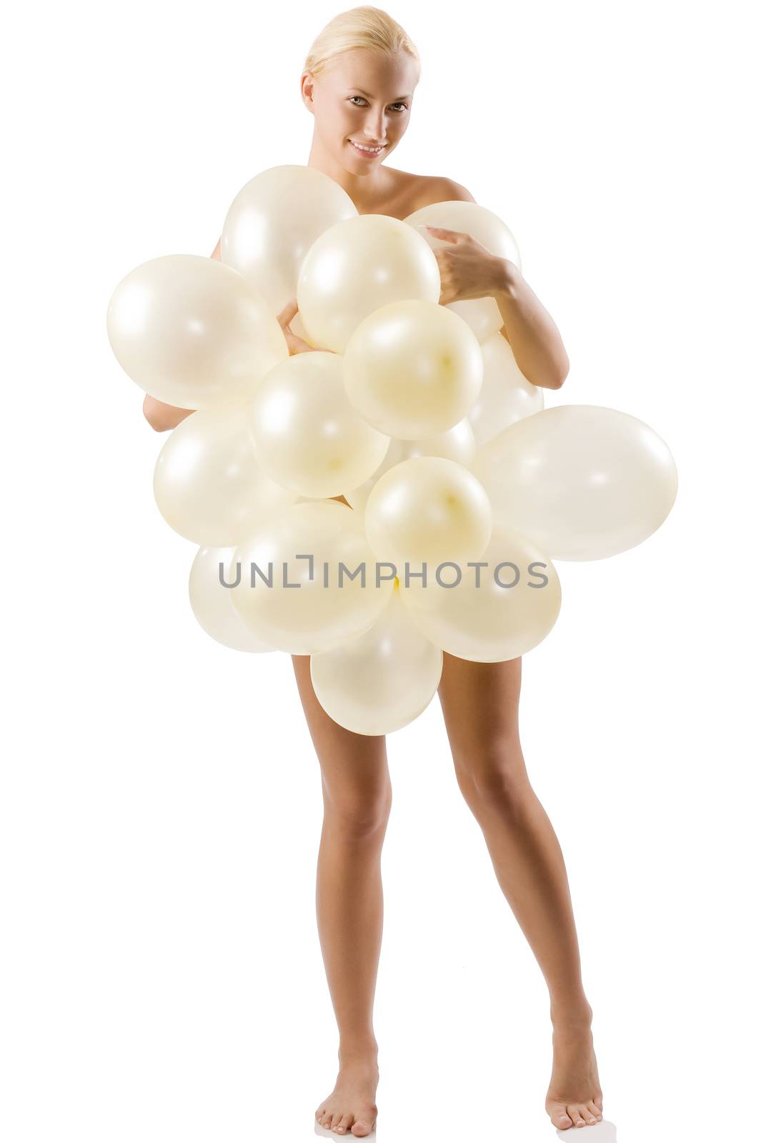 beautiful blond naked woman playing and covering her body with white balloons