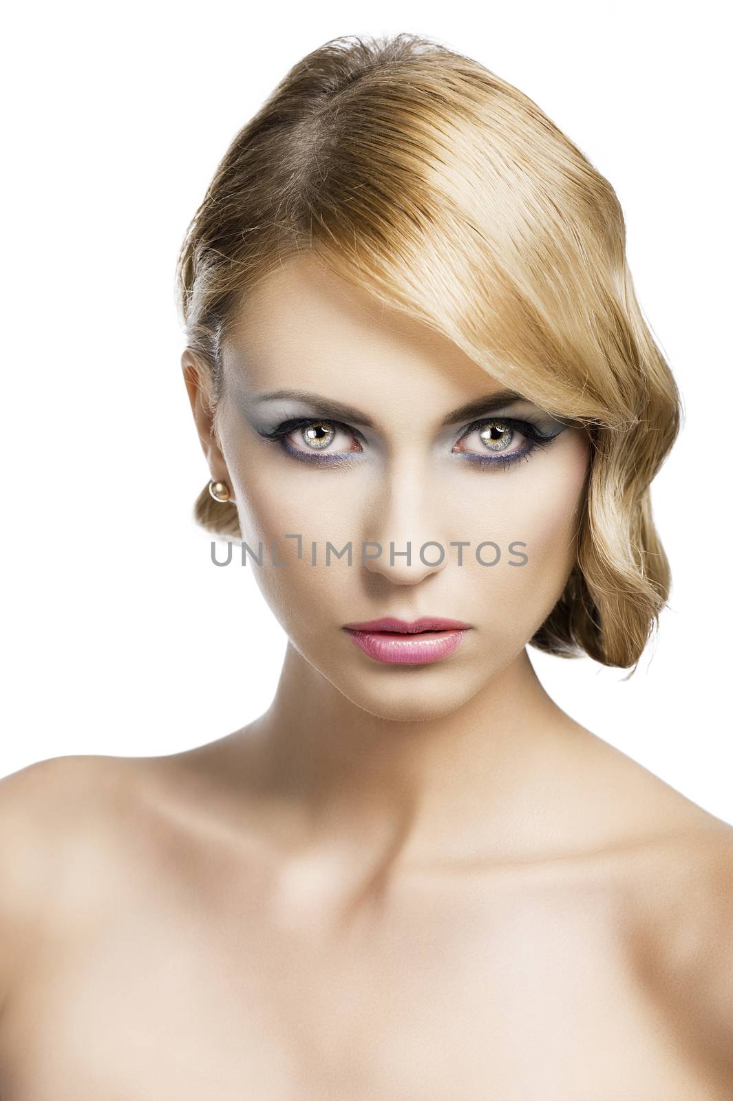 blond beautiful woman with strong make up and an old fashion hair stylish in beauty portrait close up, she is in front of the camera and looks in to the lens