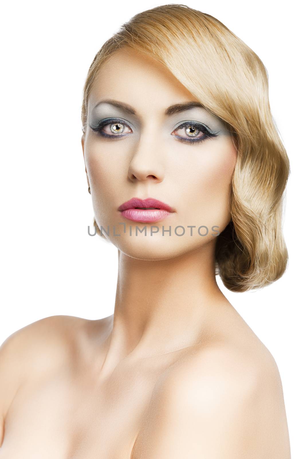 blond beautiful woman with strong make up and an old fashion hair stylish in beauty portrait close up, she is in front of the camera and looks in to the lens, she is in front of the camera and looks in to the lens.