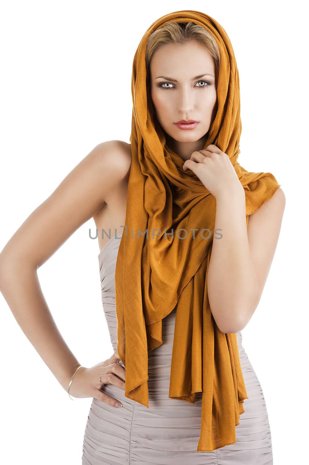elegant pretty young woman with a long scarf and a lighter dress. She is in front the camera, looks in to the lens. The right hand is on the hip and the left hand is near the neck