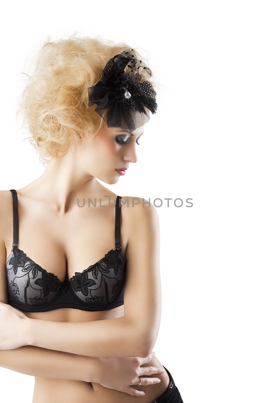 hair style with black accessory of a very beautiful blond girl wearing a black bra lingerie, she is in front of the camera with crossed arms, her face is turned in profile at left