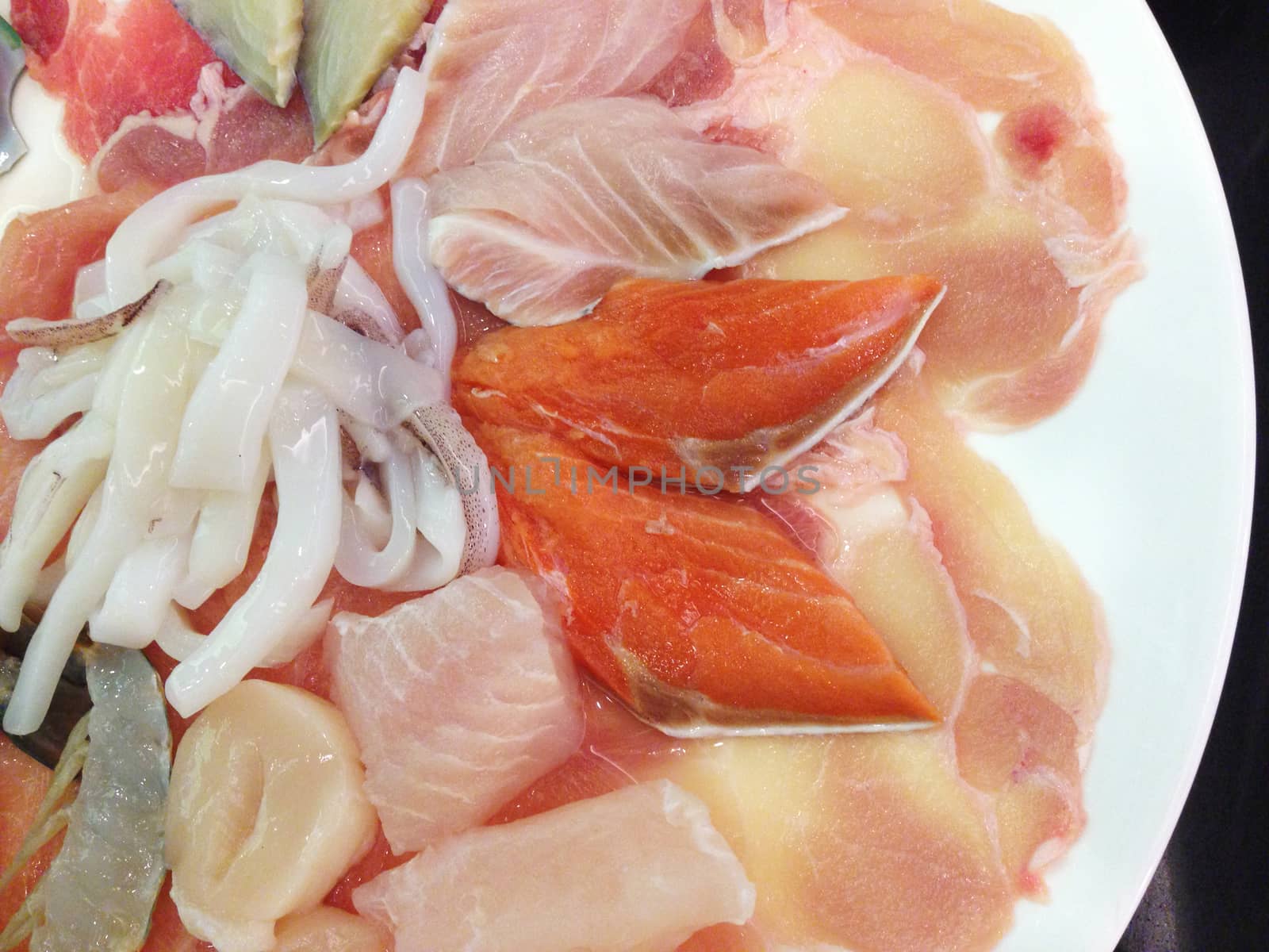 the shabu meat set with sliced pork, salmon, fish, squid and chicken