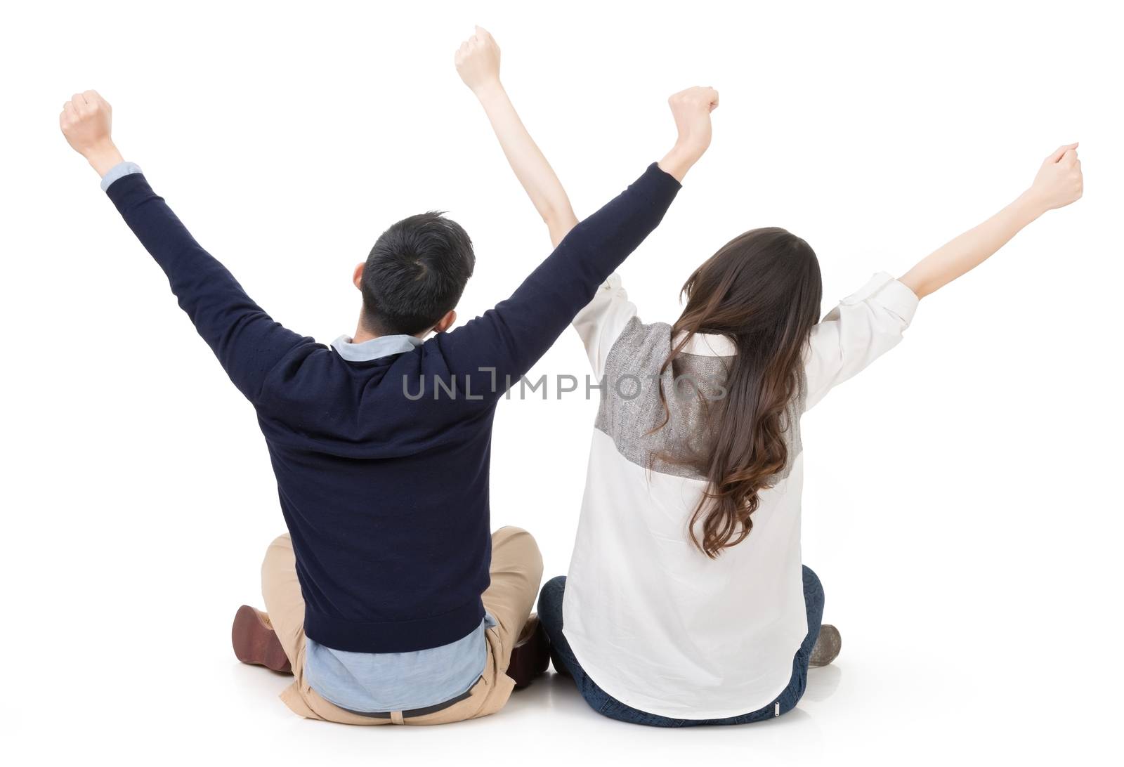 Asian young couple sitting on ground and stretching their hands feeling free, full length portrait on white background.