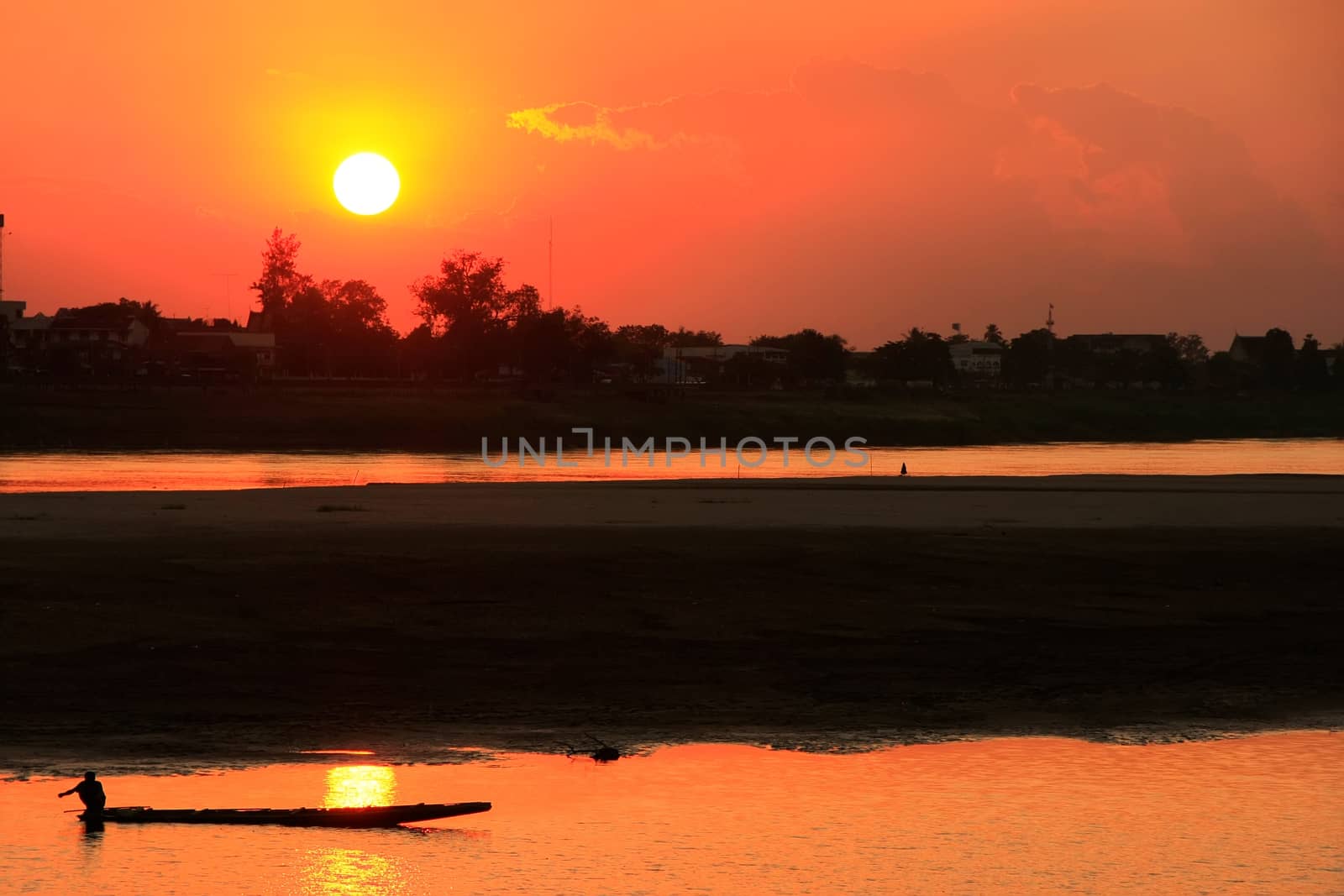 Silhouetted boat on Mekong river at sunset, Vientiane, Laos by donya_nedomam