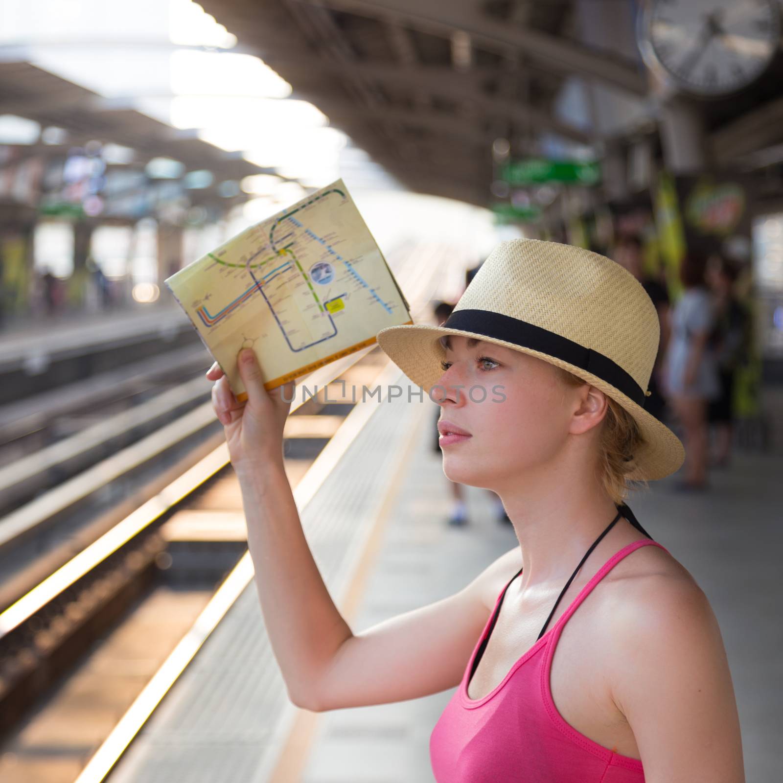 Young woman on platform of railway station. by kasto