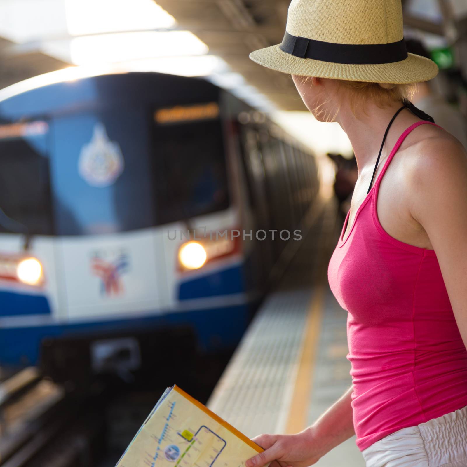 Young woman on platform of railway station. by kasto