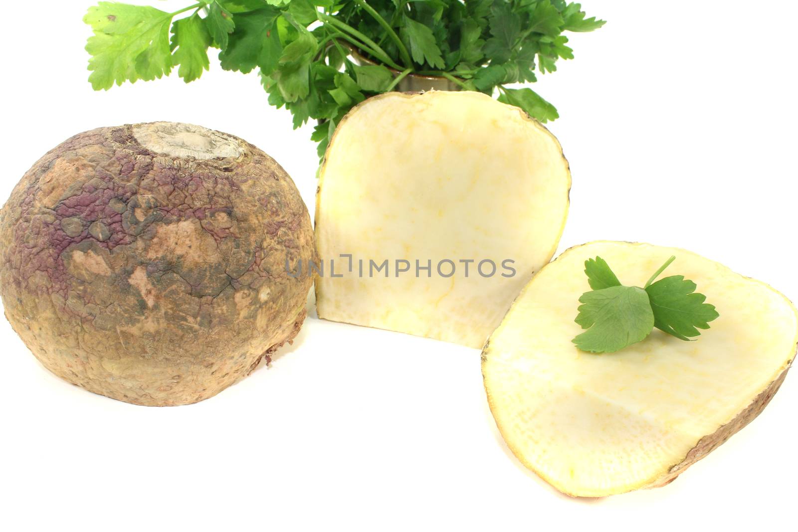 two yellow rutabaga with parsley and napkin on a light background