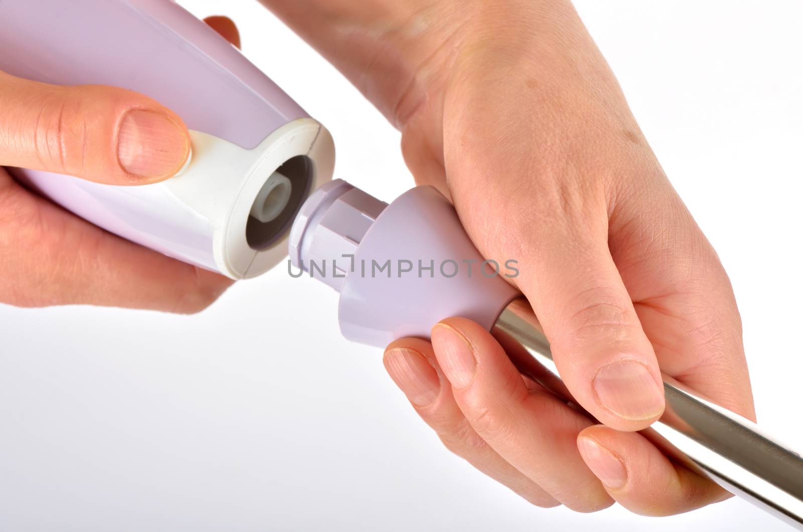 Isolated hand blender in woman hand