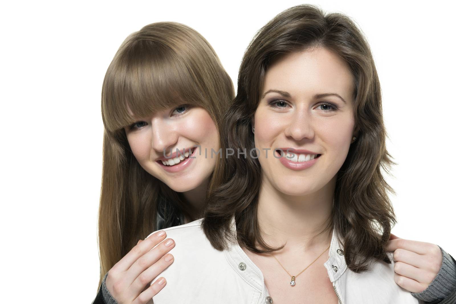 Portrait of two happy woman, blond and brunette, with black and white leather jacket, isolated on white background
