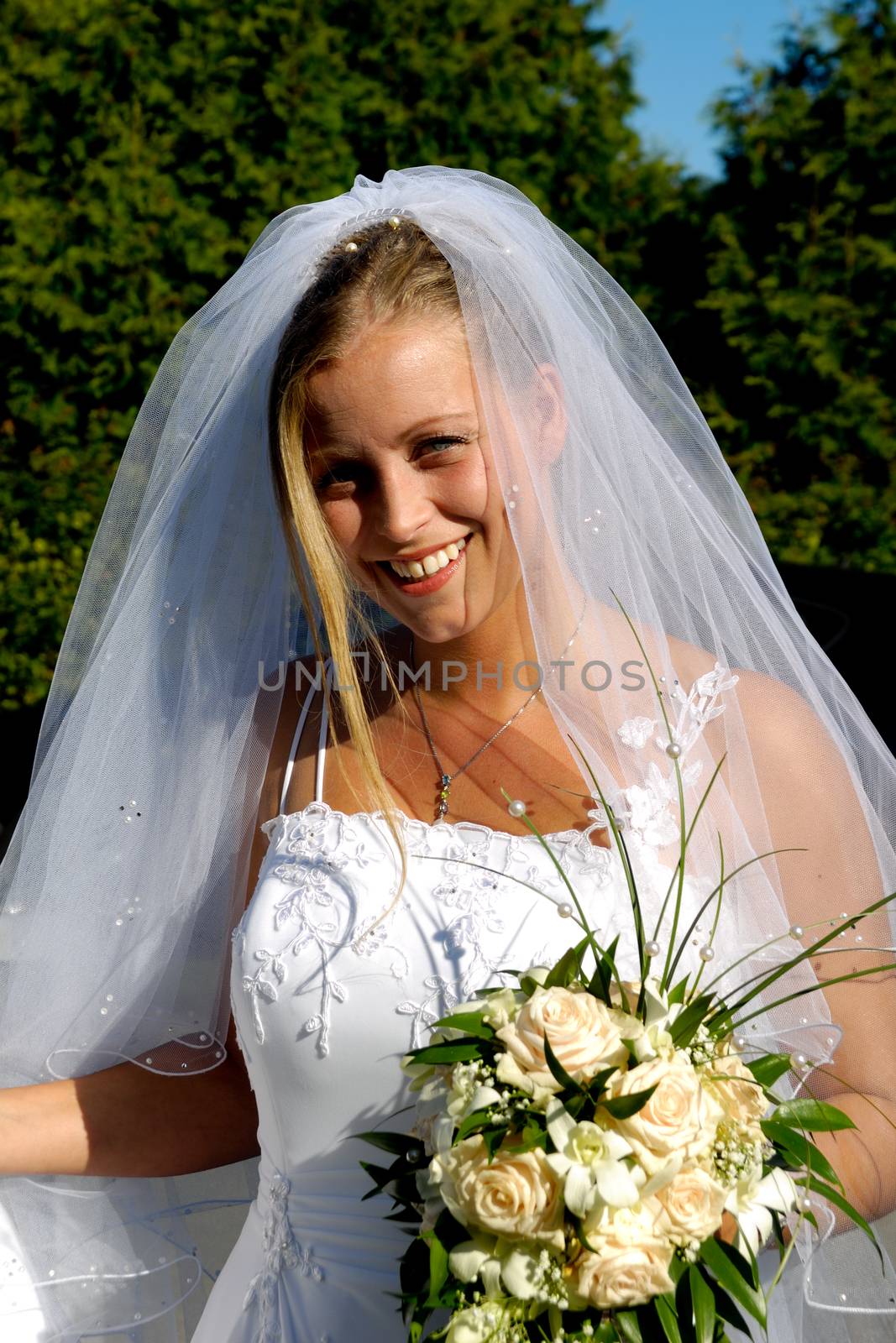 Happy smiling wedding bride with bouquet. by cfoto