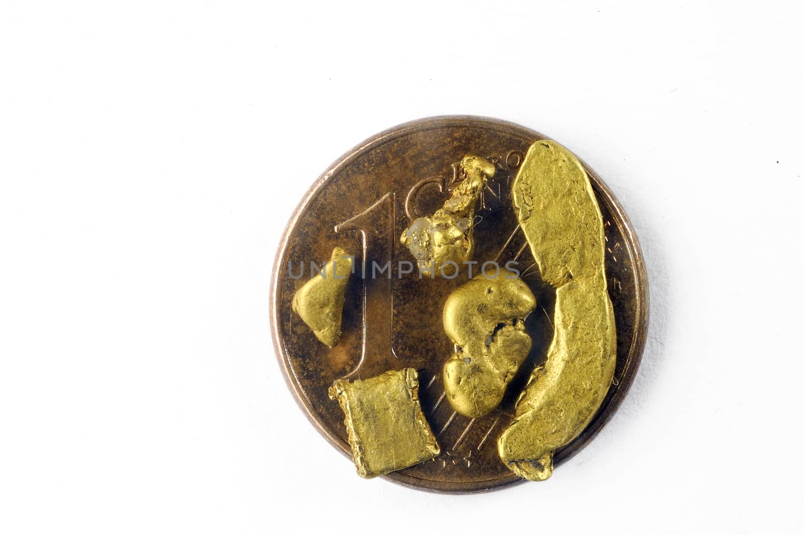 small alluvial gold nuggets found in France and placed on a one euro coin cent