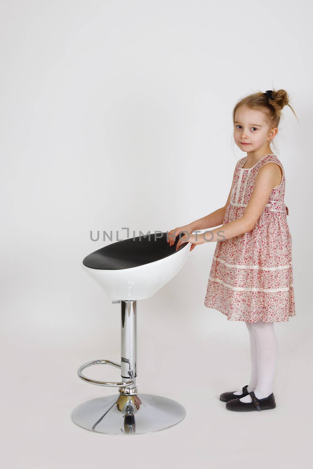 Six years old girl posing in the studio