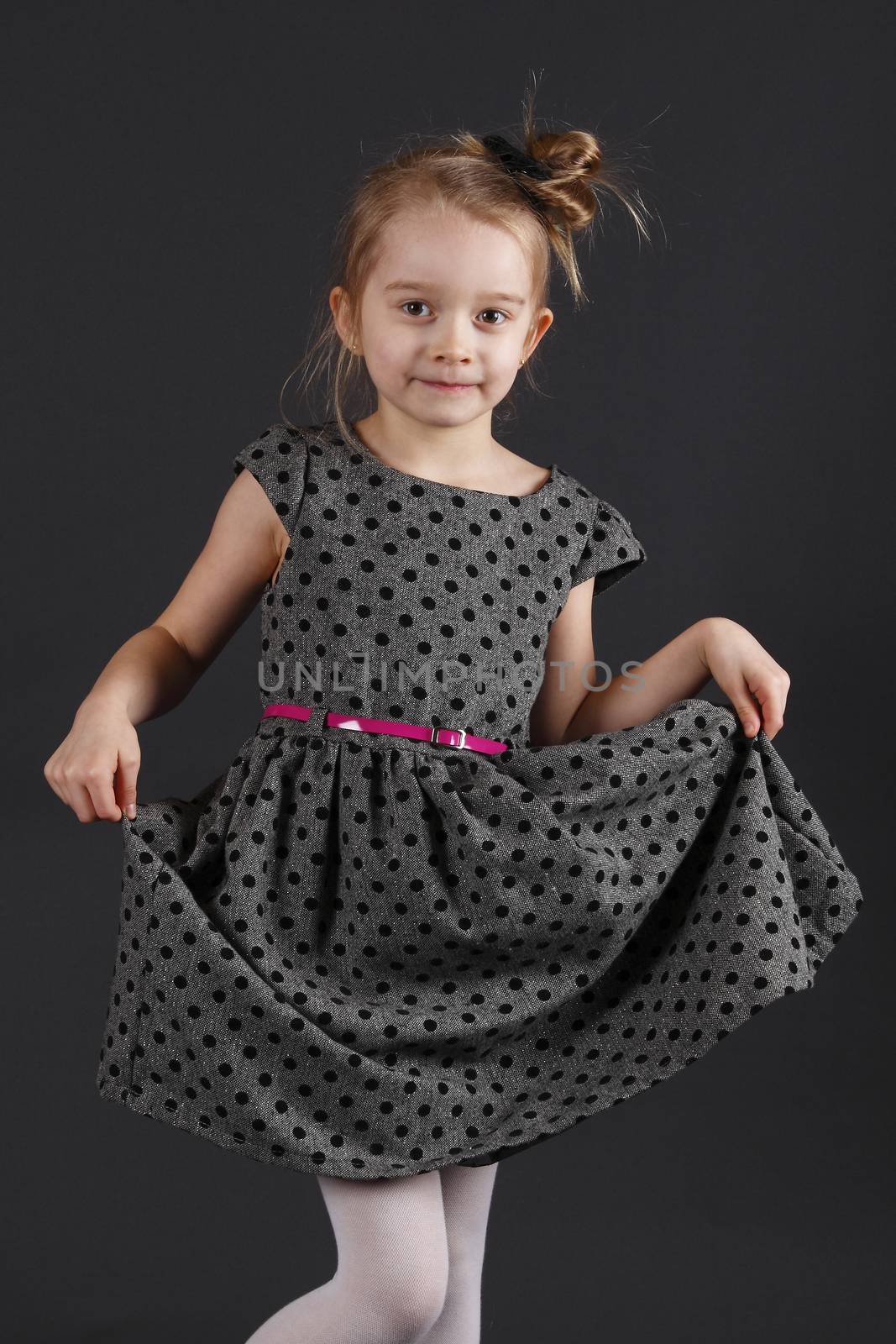 Six years old girl posing in the studio