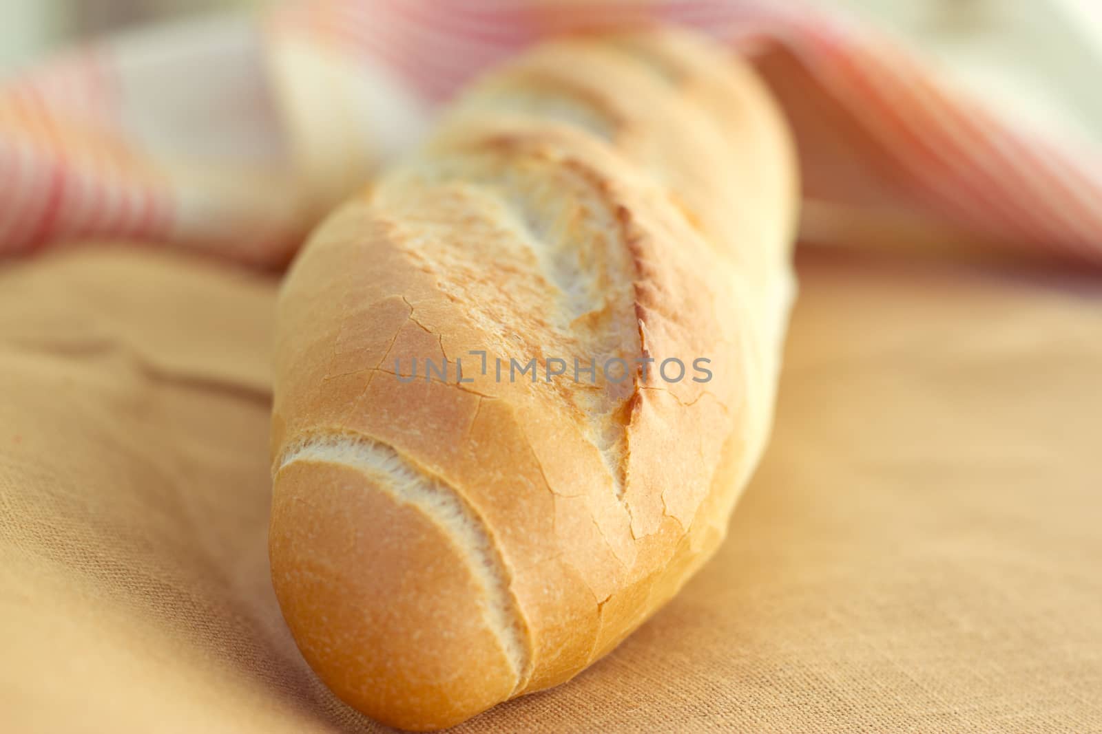 White bread loaf near the napkins on the table