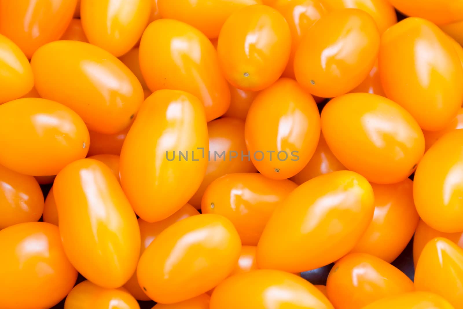 Photo of background with fresh yellow tomatos