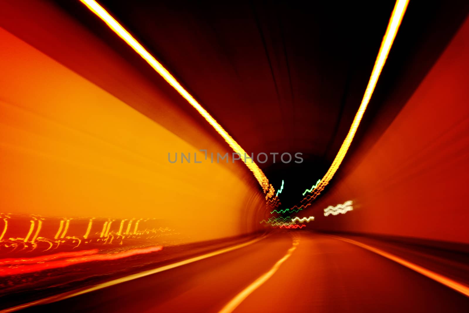 Car lights trails in a tunnel