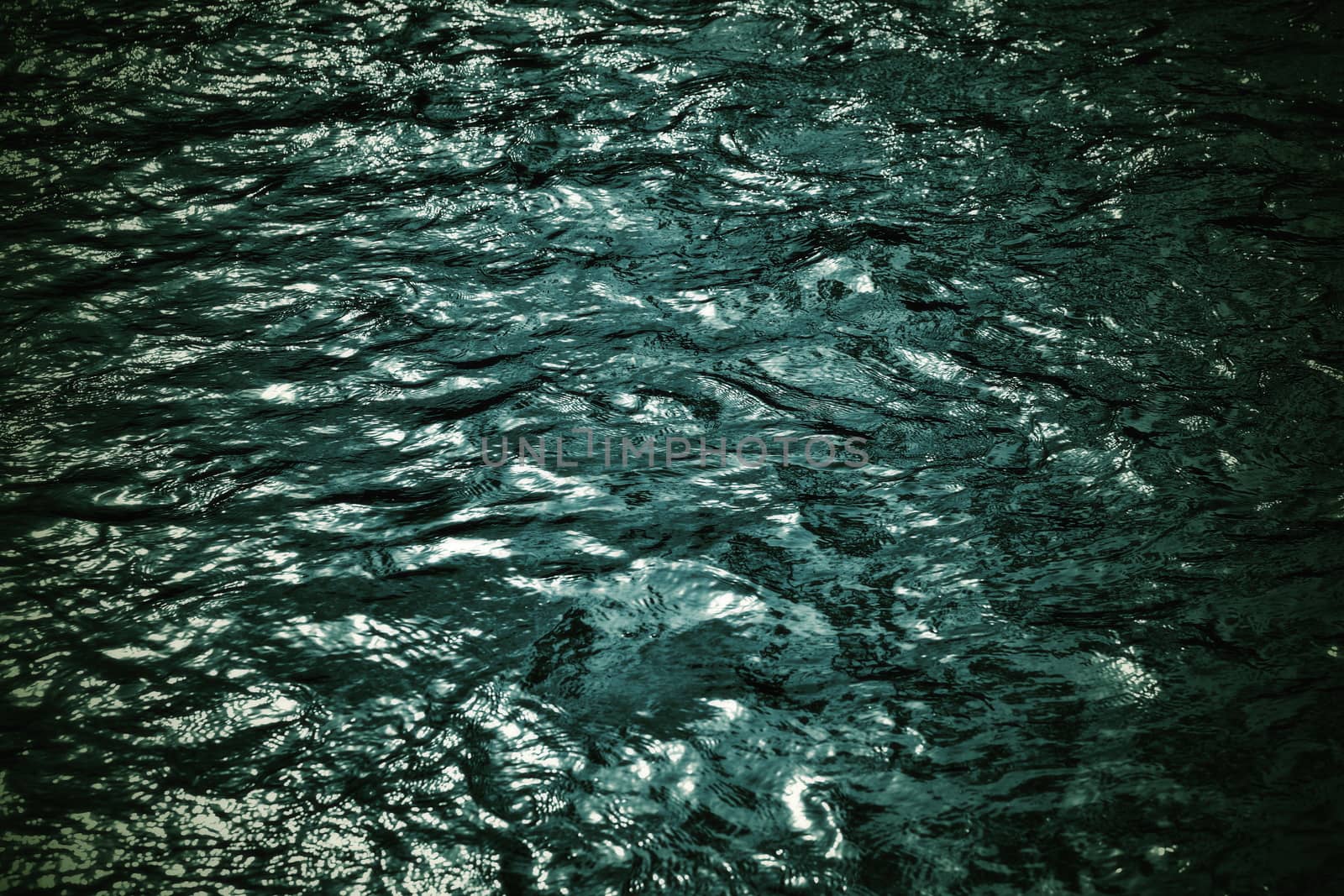 dark blue ripples on the river early evening