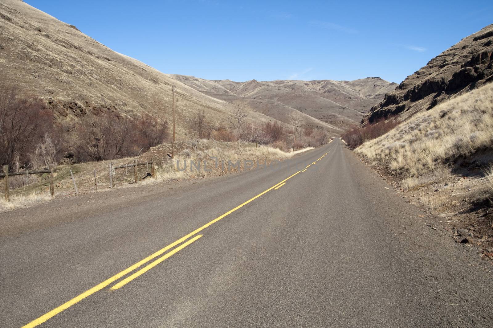 Two lane road leads off into the distance