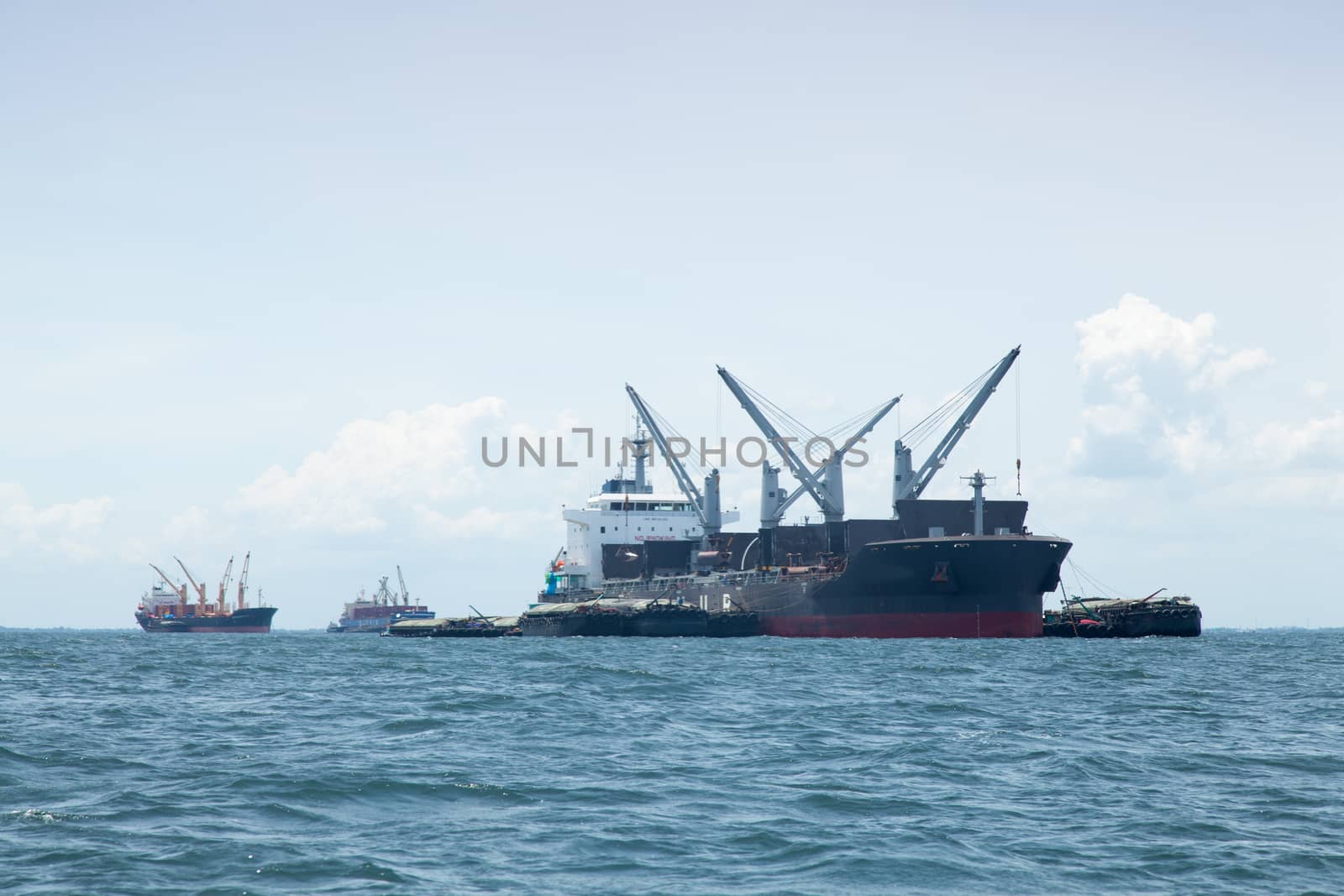 large cargo ship. Moored offshore. Transport near the docks.