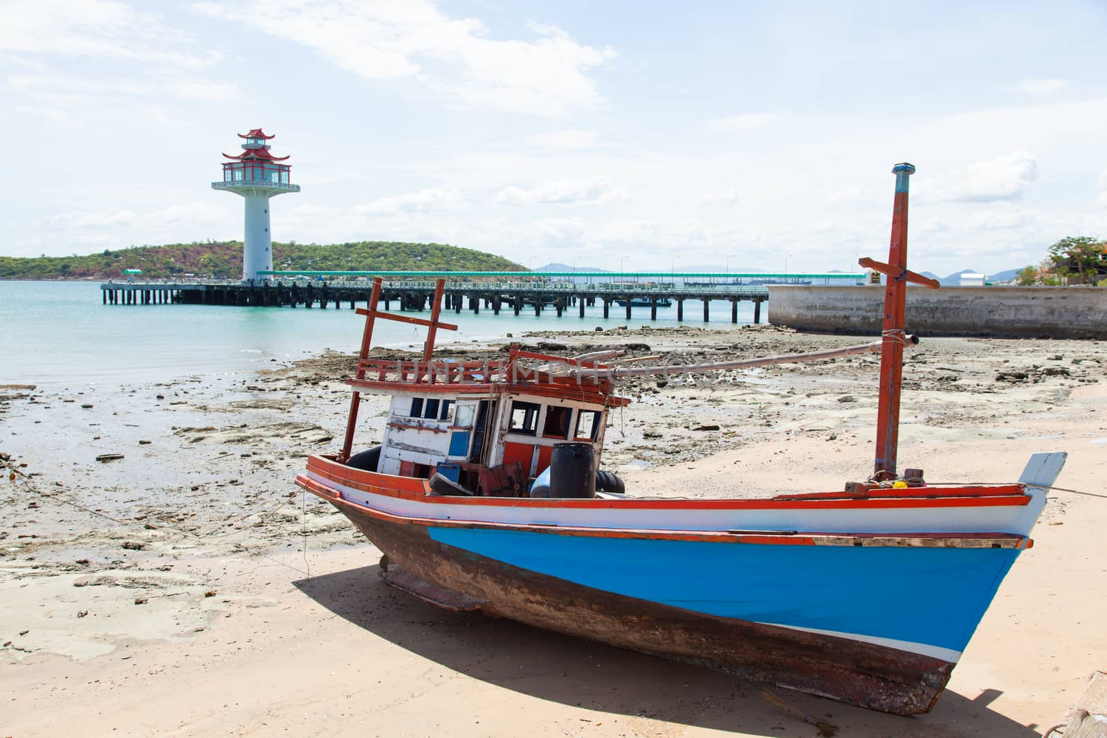 Wooden fishing boat moored on the beach. Fishing dock area of the island.
