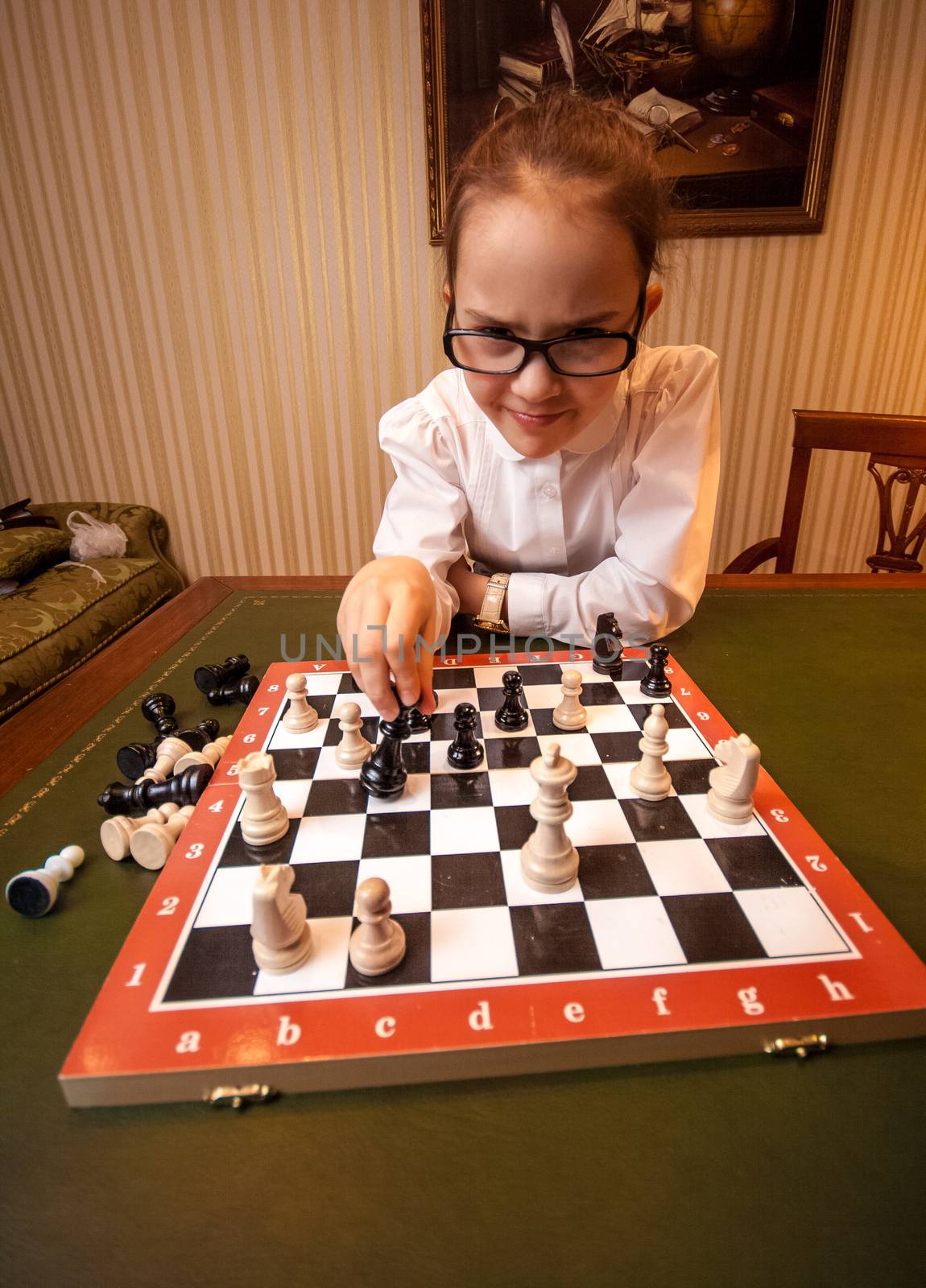 Genius girl playing chess at luxurious room