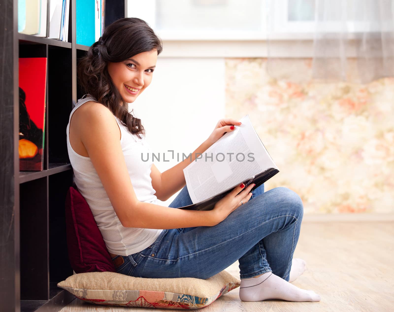 student with a lbook in a library by Astroid