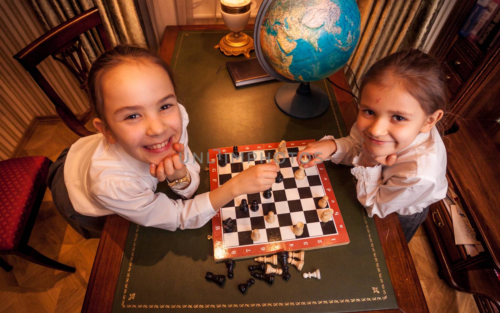Photo of two girls playing chess