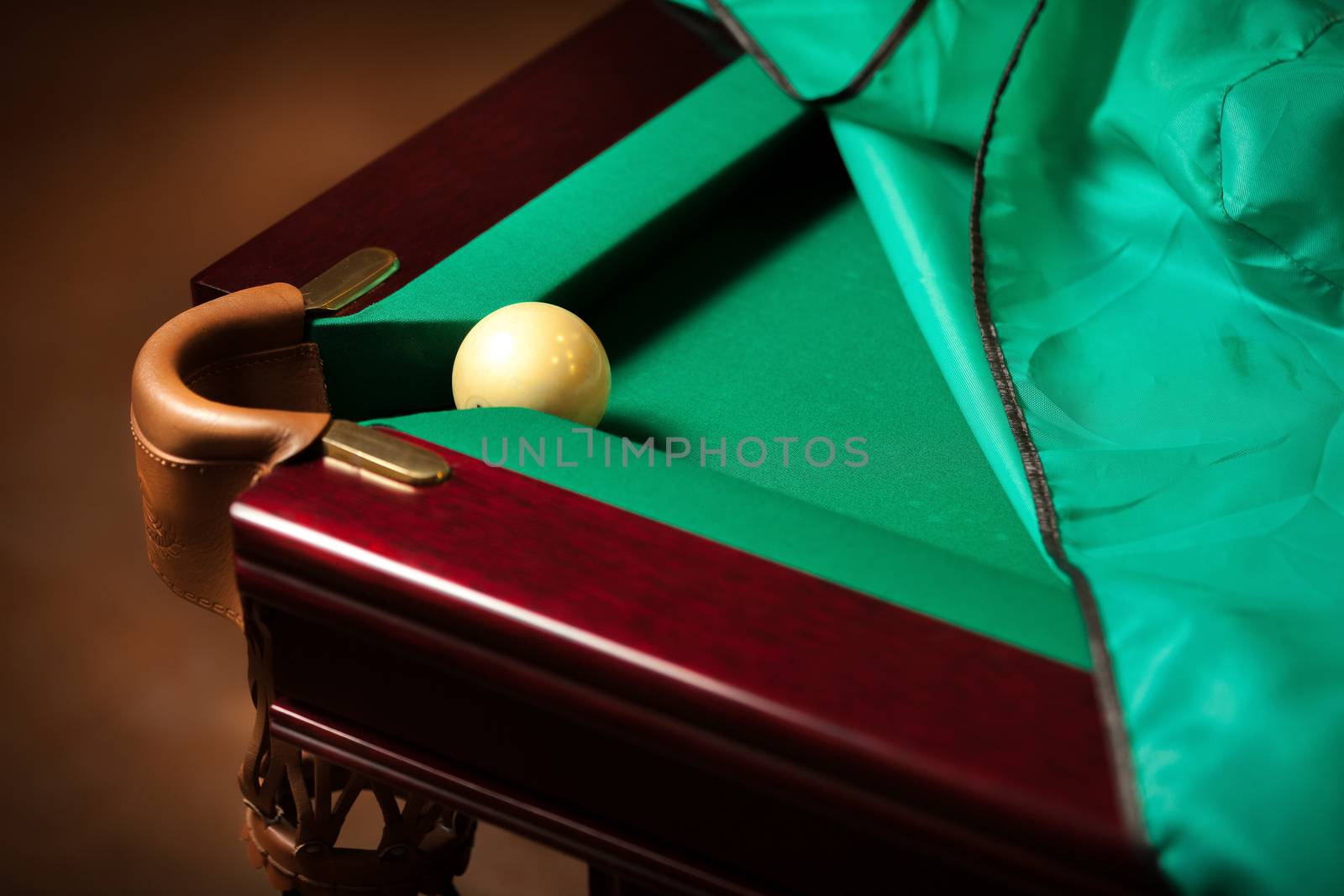Ball in billiard pocket on table by Kryzhov