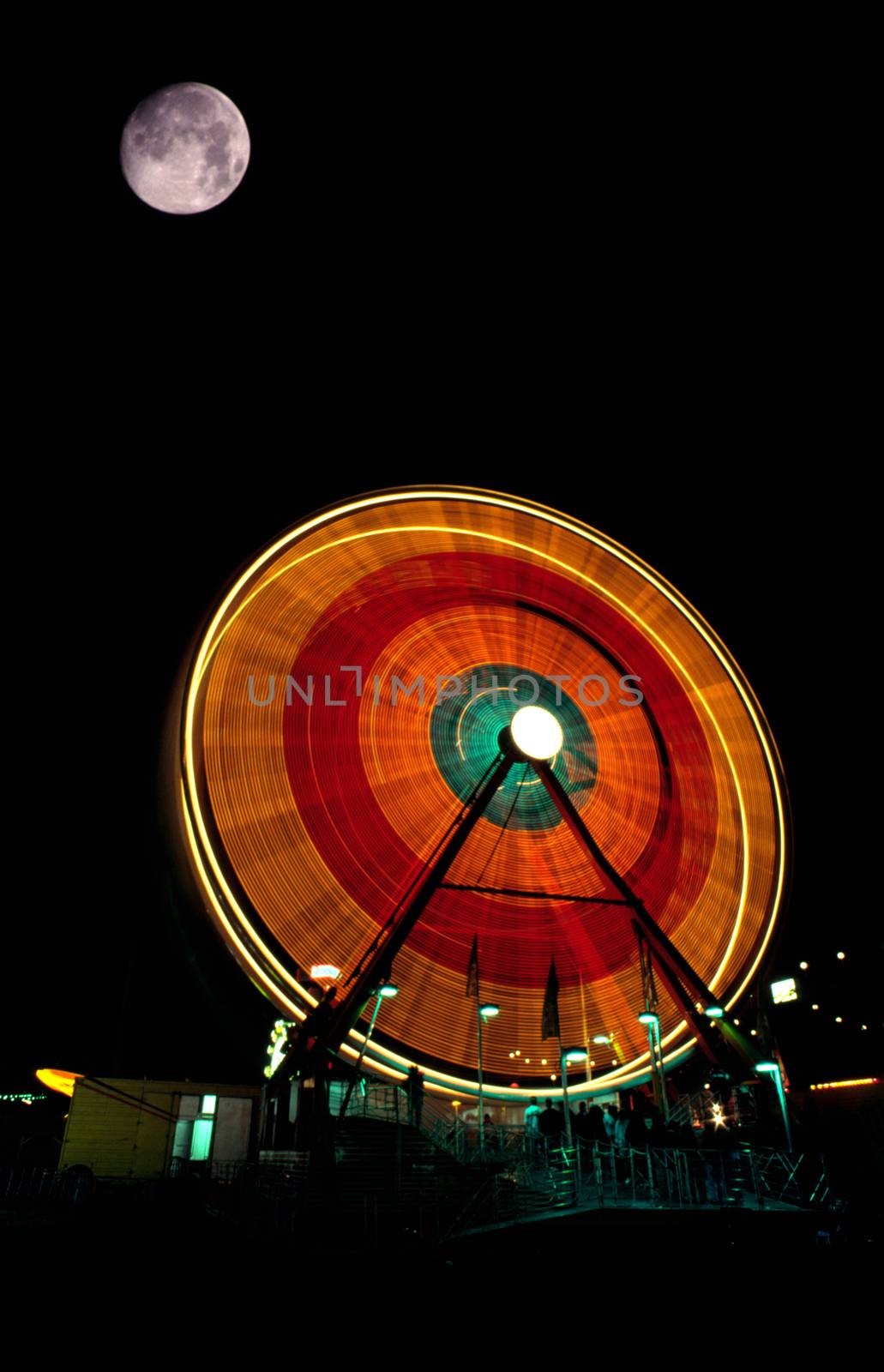 Fair Moon Full Lunar Showing over Local Fair Midway Canival Ride by ChrisBoswell