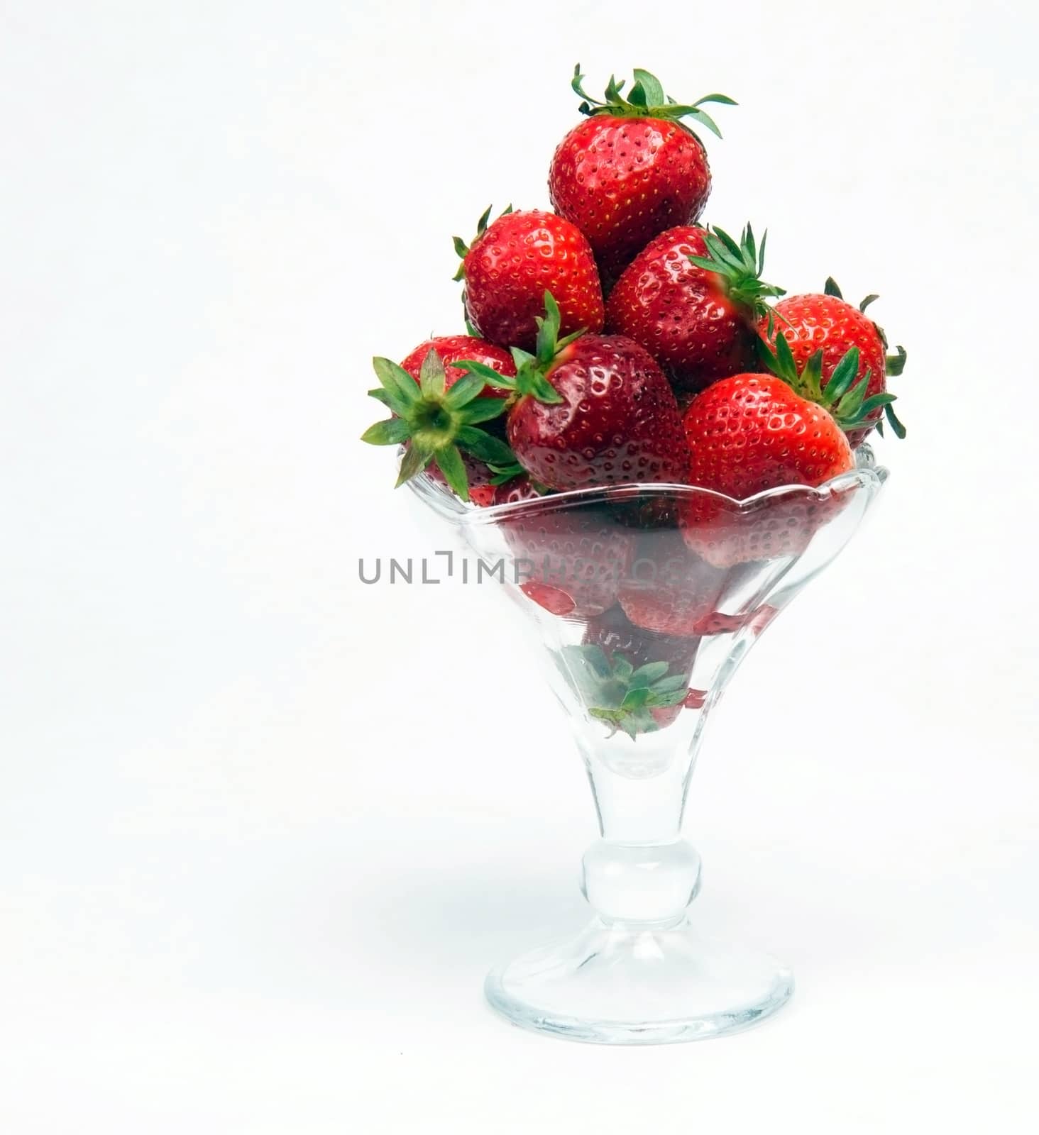 Strawberries in a pile and glass dish