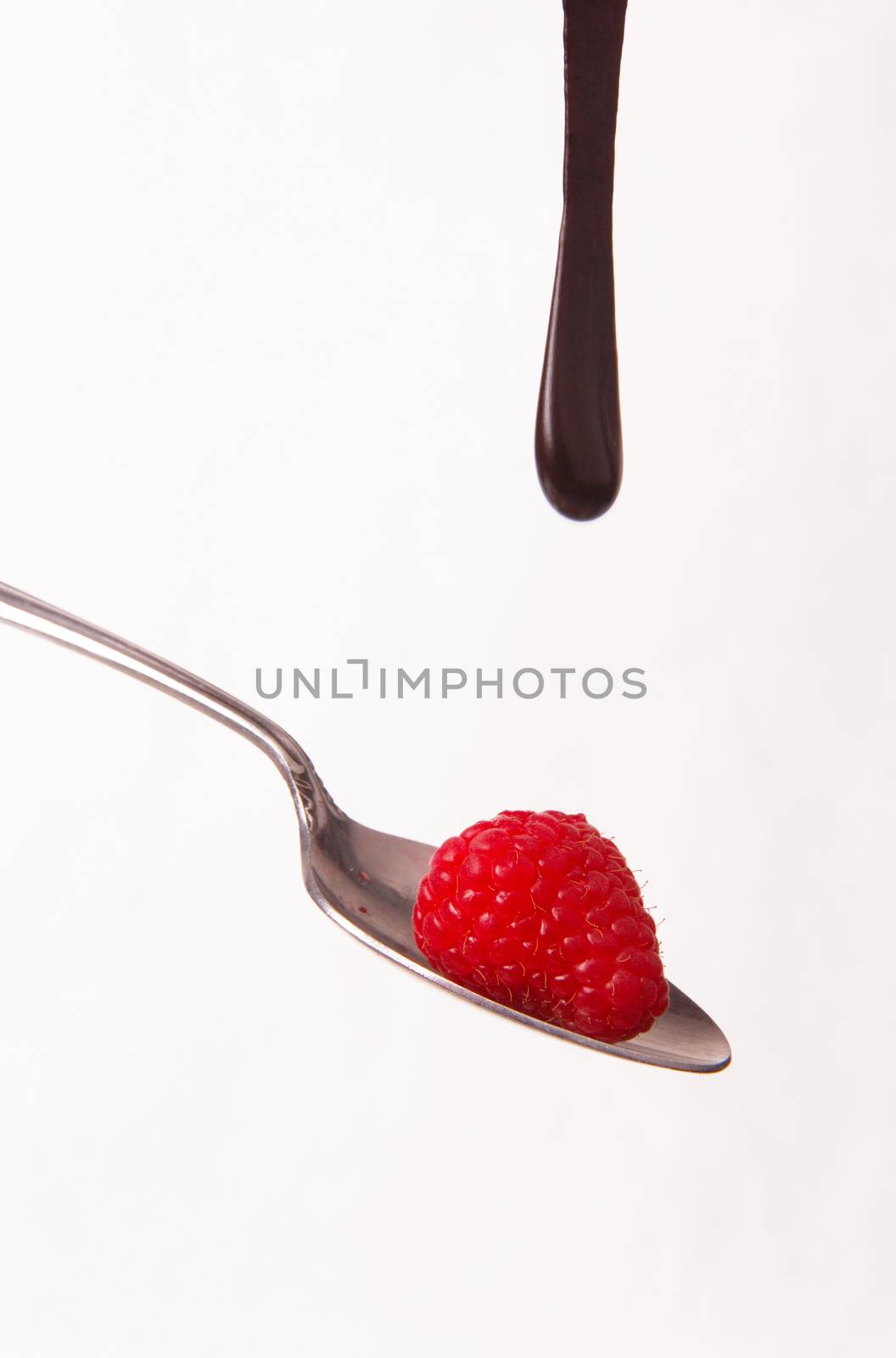 Chocolate Sauce Falling Berries Rasberries on Silver Spoon by ChrisBoswell