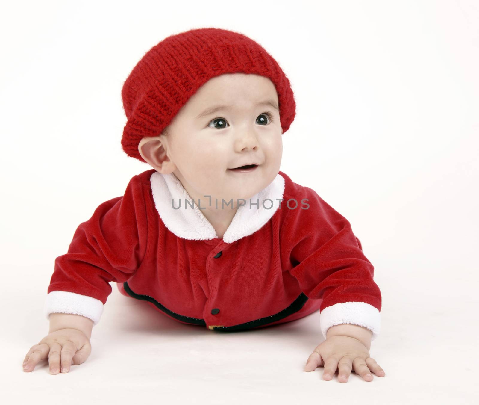 Cute Infant Boy in a horizontal composition crawling in red outfit and hat