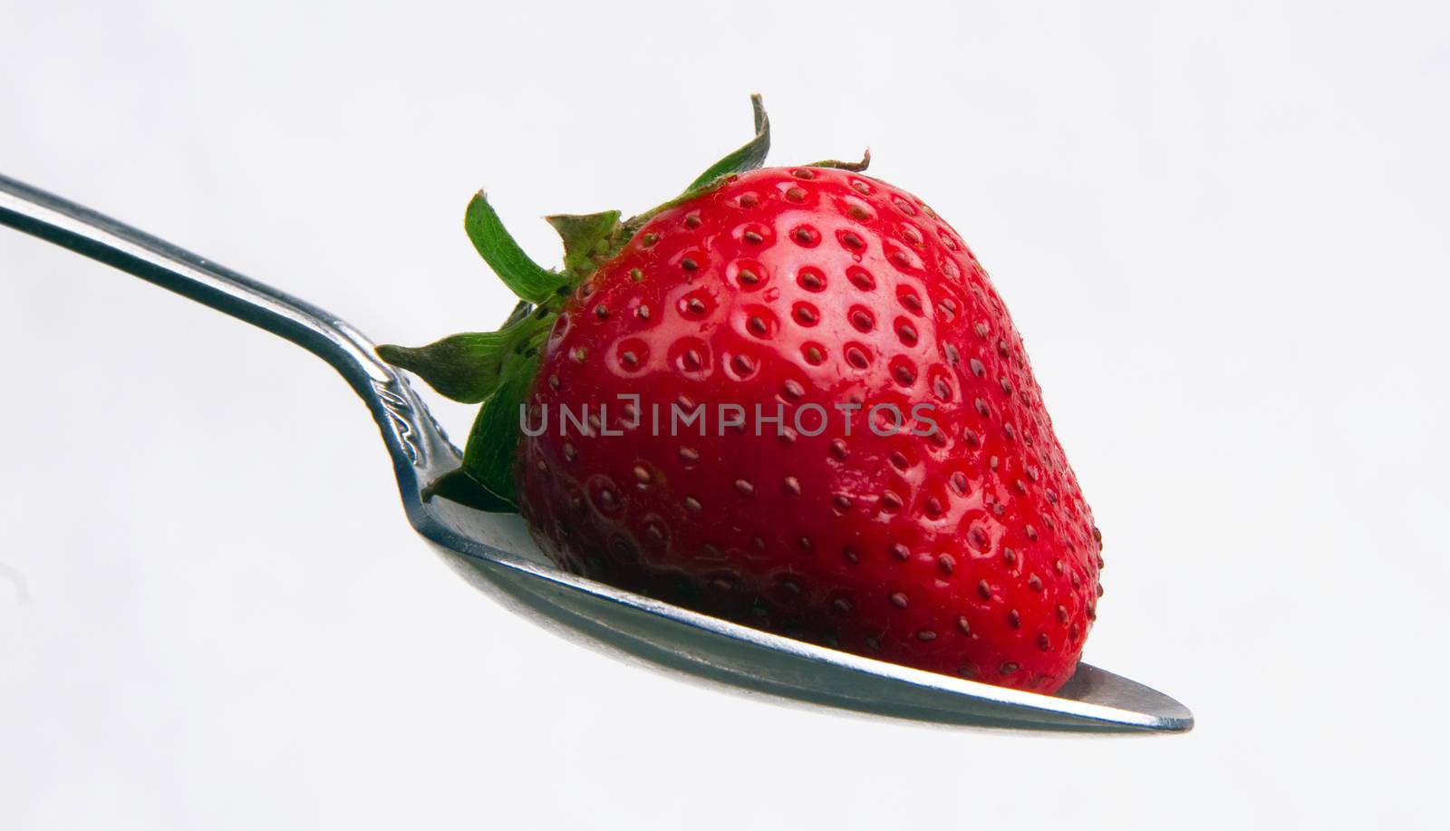 Red Raw Food Fruit Strawberry on a Silver Spoon by ChrisBoswell