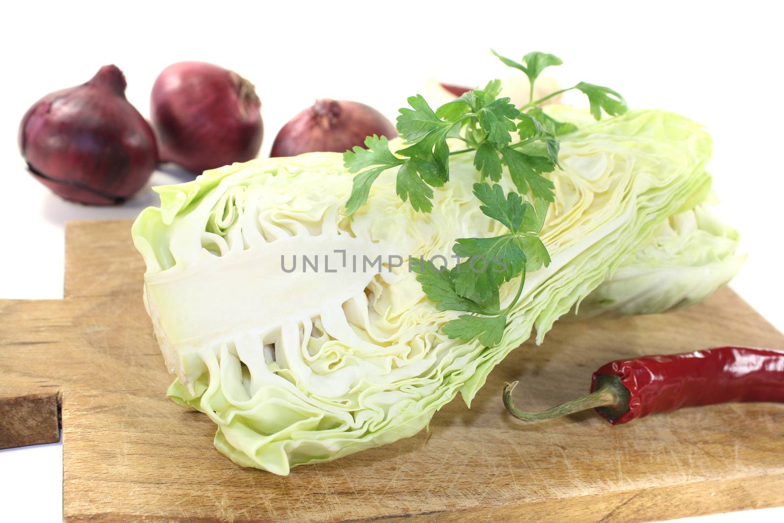 sweetheart Cabbage with board on a light background