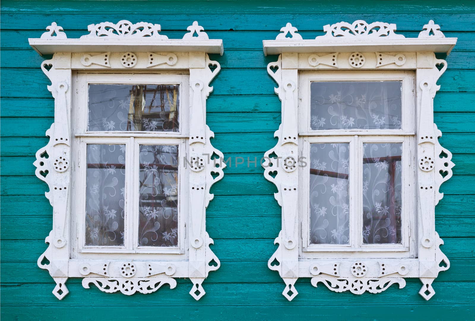 Wooden platbands on two window of an old village house